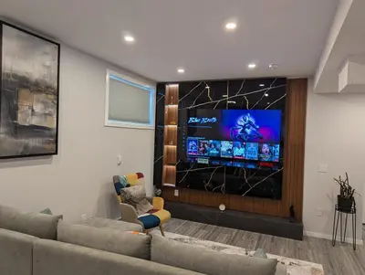 a living room with a couch and a flat screen tv at MIAT Apartment in Calgary