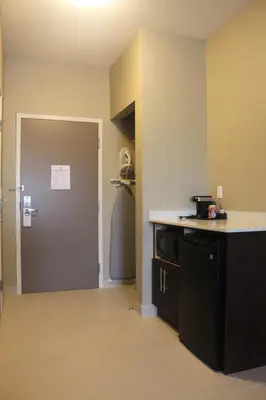 a kitchen with a counter and a door in a room at Meridian Inn & Suites Lloydminster in Lloydminster