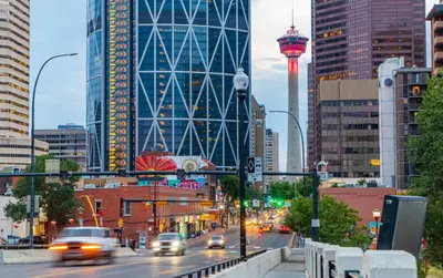 a city with cars driving down a street with buildings at Cozy 2BR Private Basement Suite, Free Parking, WiFi, 1 Hr to Banff, 20 Min to City in Calgary