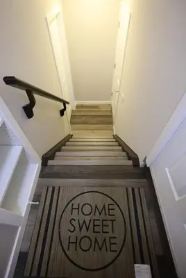 a stairway with a home sweet home sign on the floor at Cozy 2BR Private Basement Suite, Free Parking, WiFi, 1 Hr to Banff, 20 Min to City in Calgary