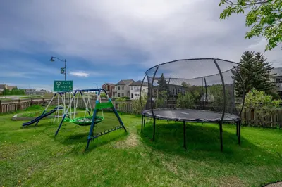 two trampolines in the grass in a yard at The Cloud off 16th - 2bd 1 ba in Calgary
