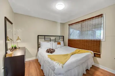 a bedroom with a large bed and a window at Dreams off 16th in Calgary