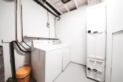 a laundry room with a washer and dryer at Dreams off 16th in Calgary