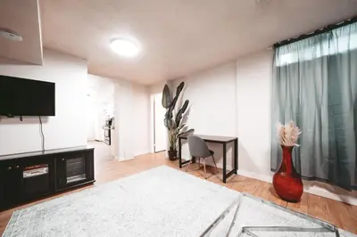 a living room with a television and a vase at Dreams off 16th in Calgary