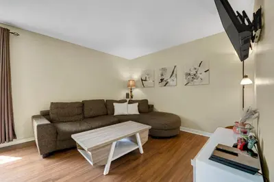 a living room with a couch and a table at Dreams off 16th in Calgary