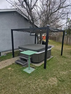 a trampoline with a picnic table in a yard at Dreams off 16th in Calgary