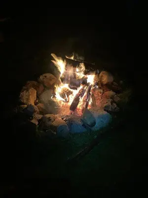 a fire pit with teddy bears around it at night at Gambier Lavender Lodge and Homestead in Gibsons