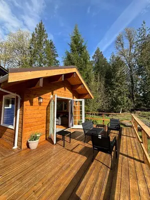 a wooden deck with chairs and a pavilion at Gambier Lavender Lodge and Homestead in Gibsons
