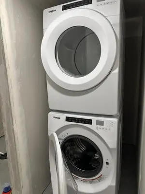 a washing machine and a dryer in a room at The Modern Nest-one bedroom basement suite in Calgary