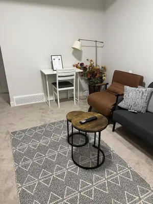 a living room with a couch and a table at The Modern Nest-one bedroom basement suite in Calgary