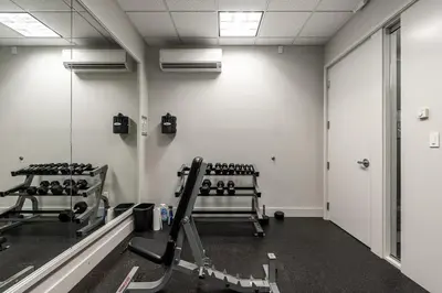 a gym with two tread machines and a mirror at Gorgeous Unit in the Heart of Downtown in Vancouver