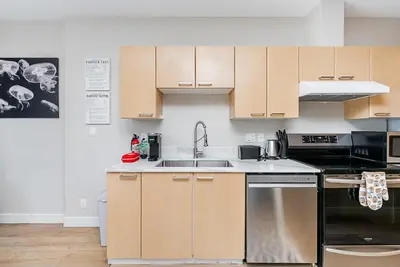 a kitchen with wooden cabinets and a sink at Gorgeous Unit in the Heart of Downtown in Vancouver