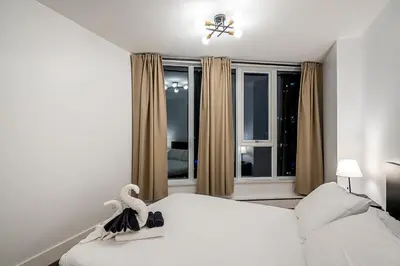 a bedroom with a bed with a swan on it at Gorgeous Downtown Unit with City Views in Vancouver