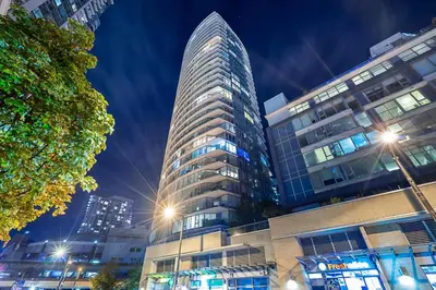 a tall building in a city at night at Gorgeous Downtown Unit with City Views in Vancouver