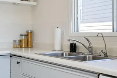 a kitchen counter with a sink and a window at Hoodoo Hideout - 2BR House - Family Retreat - King Suite in Drumheller