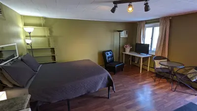 a bedroom with a bed and a desk with a computer at Deerview Lodge & Cabins - Princeton BC in Princeton