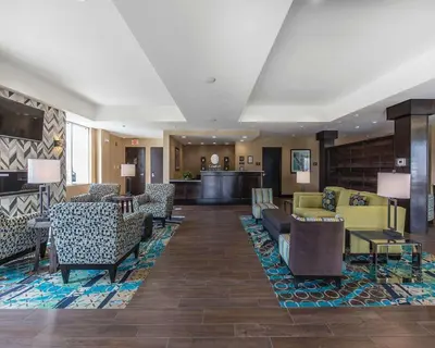 a lobby with couches and chairs in a hotel at Comfort Inn & Suites Airport North in Calgary