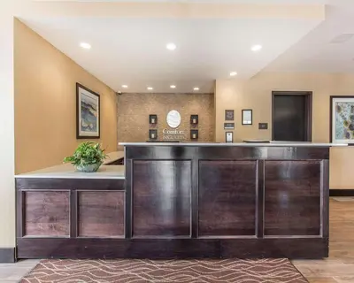 a lobby with a reception desk in a building at Comfort Inn & Suites Airport North in Calgary