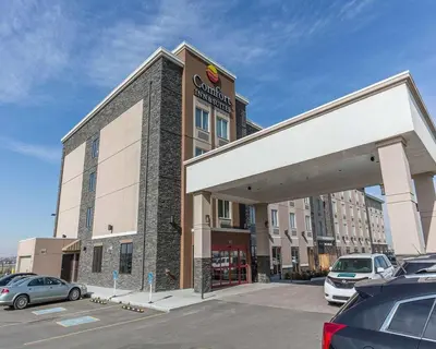 a shopping center with cars parked in a parking lot at Comfort Inn & Suites Airport North in Calgary