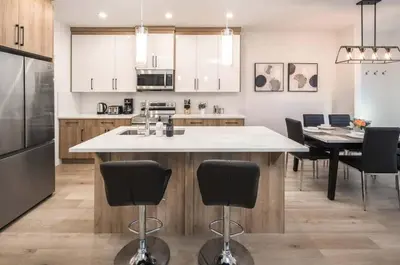 a kitchen with a large island in the middle at Group Stay, Sleeps 16! Near Downtown - 6BR Full Duplex, 2 Kitchens! FREE Banff Pass in Calgary