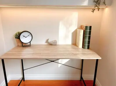 a clock sitting on top of a table with books at Modern 3BR Near Airport & DT in Calgary
