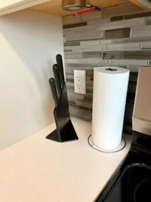 a roll of paper towels and a knife on a counter at Modern 3BR Near Airport & DT in Calgary