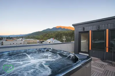 a hot tub on the roof of a house at Downtown Loft with Rooftop Hot Tub by StayIn in Fernie