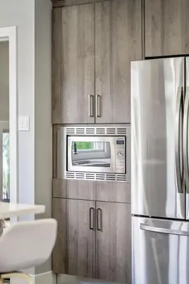 a kitchen with a refrigerator and a microwave at The Experience - Pool Hot Tub Theater Games Rm Pub in Calgary