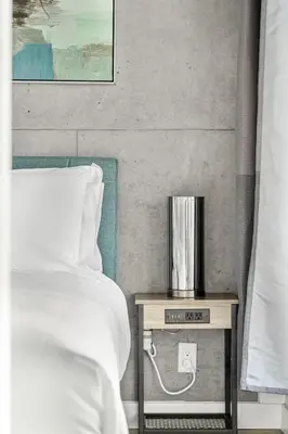 a bedroom with a bed and a nightstand with a clock at Executive Sky LUX - 2 BD 2BA Views Pool Patio & Gym in Calgary