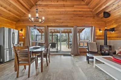 a kitchen and dining room with a table and chairs at Lake Vibes 3 BD 1 BA Cottage steps from the Lake in Lacombe