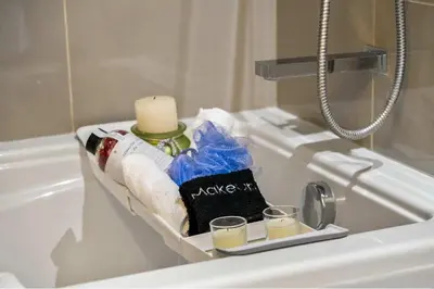 a bathroom with a candle and two glasses on a sink at Miso 2 BD - Skyline View Patio Gym Pool & AC in Calgary
