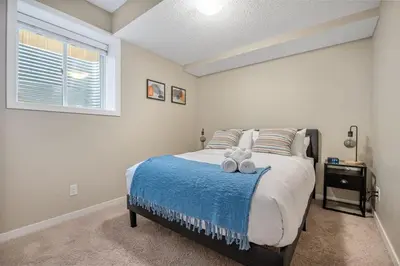 a bedroom with a bed with two teddy bears on it at The Trenta - 4BD 3BA 2 Kitchen Stunner in Calgary