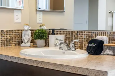 a bathroom counter with a sink in a bathroom at The Trenta - 4BD 3BA 2 Kitchen Stunner in Calgary
