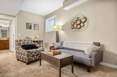 a living room with a couch and a chair at The Grande 1BD 1BA - Full Kitchen Guest Suite in Calgary