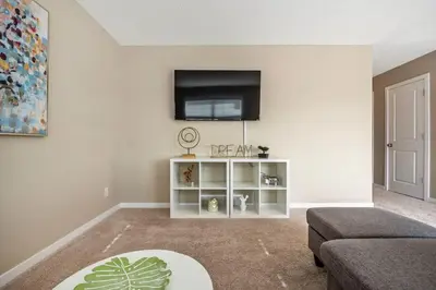 a living room with a flat screen tv on a wall at The Venti - 3BD 2BA Yard Garage & Upper Suite in Calgary