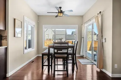 a dining room with a table and chairs and a ceiling fan at The Venti - 3BD 2BA Yard Garage & Upper Suite in Calgary