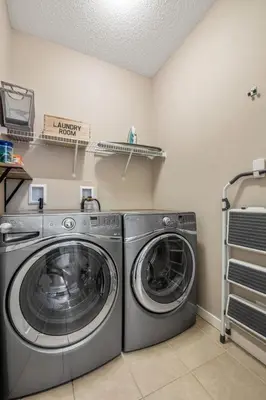 a laundry room with a washer and dryer at The Venti - 3BD 2BA Yard Garage & Upper Suite in Calgary
