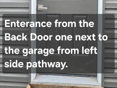an entrance from the back door to the garage from left side pathway at Cozzy Cityscape & Airport Retreat in Calgary