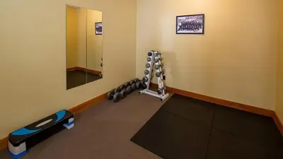 a room with a gym with a mirror and a treadmill at Riverside Way by Fernie Lodging Company in Fernie