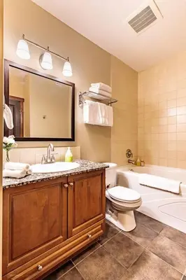 a bathroom with a sink and a toilet and a bath tub at Sun Drenched Escape - 50 Percent Off Apr - May in Canmore
