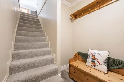 a staircase in a house with a bench at Gondola Heights by Outpost Whistler in Whistler