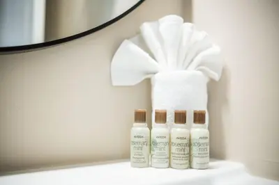 three bottles of lotion sitting on a counter with a towel at Gondola Heights by Outpost Whistler in Whistler