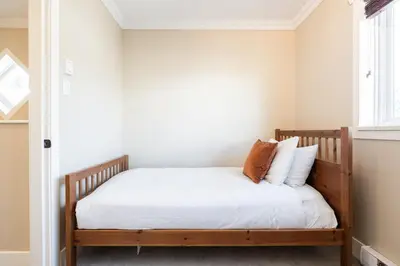 a bedroom with a bed with white sheets and pillows at Gondola Heights by Outpost Whistler in Whistler