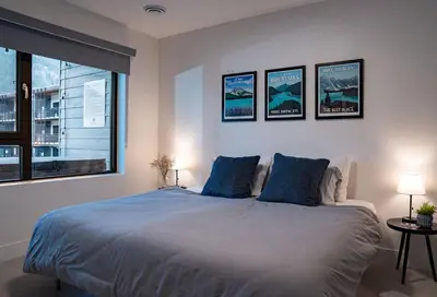 a bedroom with a large bed with blue pillows at Alpenstoke in Revelstoke
