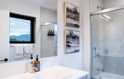 a bathroom with a shower and a sink and a tub at Alpenstoke in Revelstoke