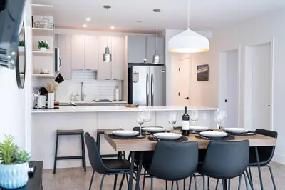 a kitchen with a dining room table and chairs at Alpenstoke in Revelstoke
