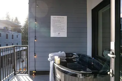 a bath tub sitting on the front of a house at Alpenstoke in Revelstoke