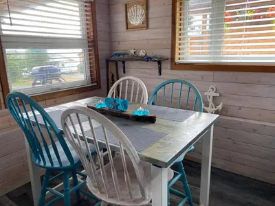 a wooden table with four chairs around it in a cabin at Passage view in Campbell River