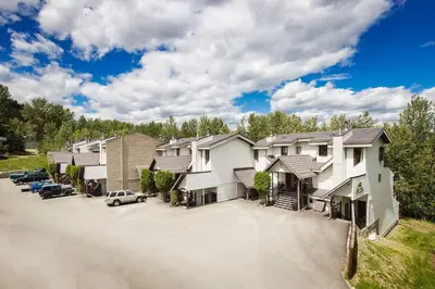 a row of houses with a parking lot at Mountain Edge Resort Inn by StayIn in Kimberley
