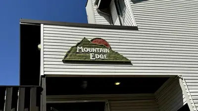 a sign on the side of a building at Mountain Edge Resort Inn by StayIn in Kimberley